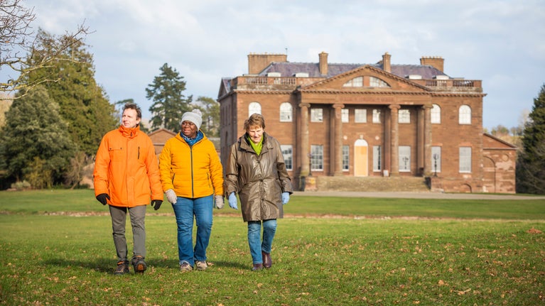 Visitors on a winter walk in the grounds at Berrington Hall, Herefordshire